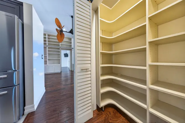 a view of a hallway with wooden floor and entryway