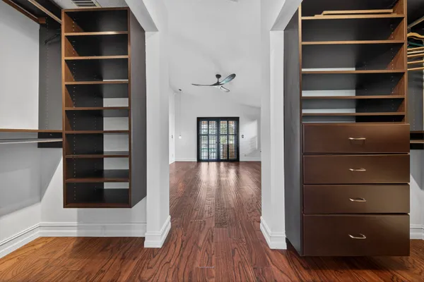 a view of walk in closet with empty racks