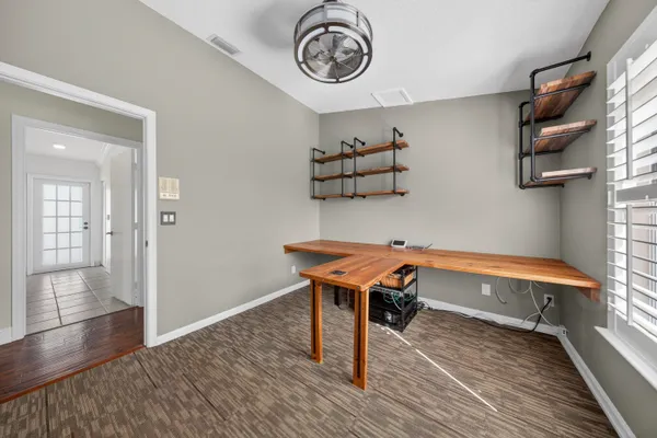a room with wooden floor and a window