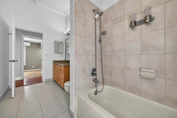 a bathroom with a tub a toilet and a shower