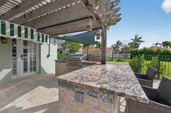 a view of a porch with furniture and garden