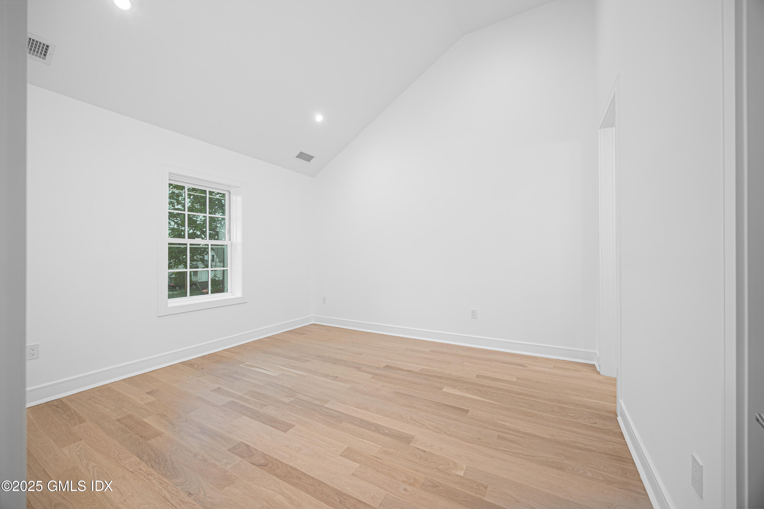 82 Josephine Evaristo Avenue Greenwich, CT 06830 - Photo 11 of 13 a view of an empty room with wooden floor and a window