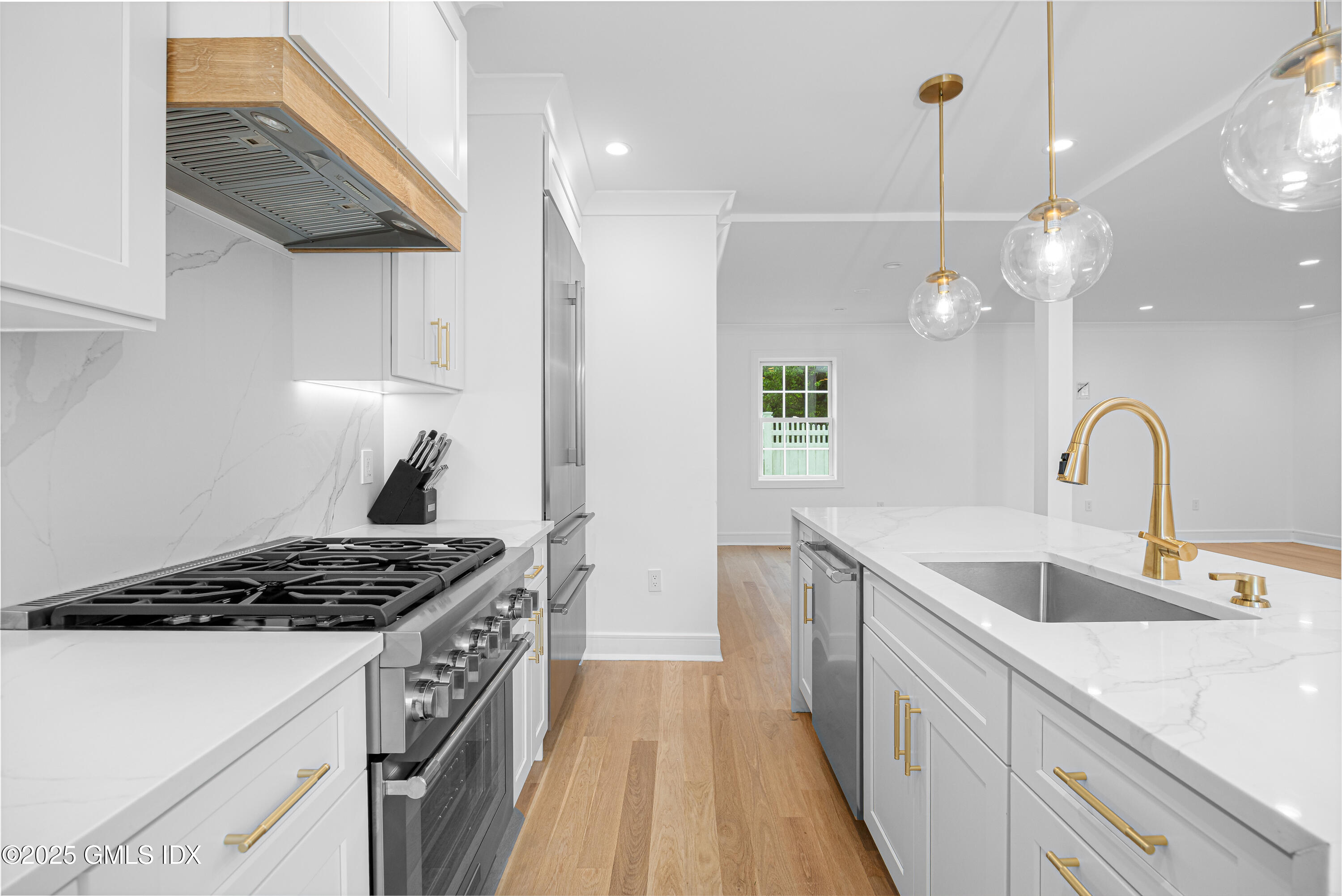 82 Josephine Evaristo Avenue Greenwich, CT 06830 - Photo 2 of 13 a kitchen with kitchen island stainless steel appliances a sink a stove and a wooden floors