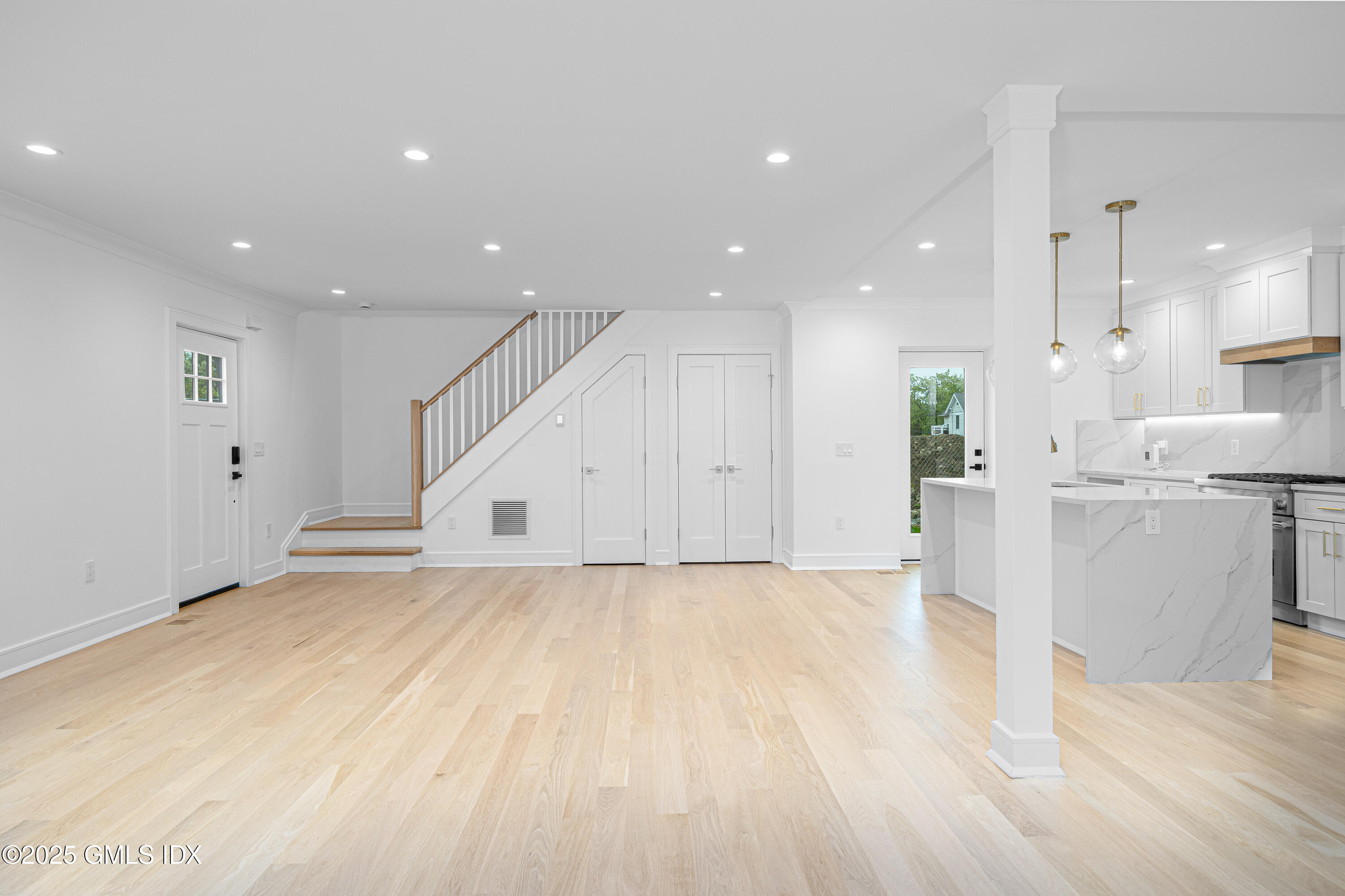 82 Josephine Evaristo Avenue Greenwich, CT 06830 - Photo 5 of 13 a view of an empty room with wooden floor and windows
