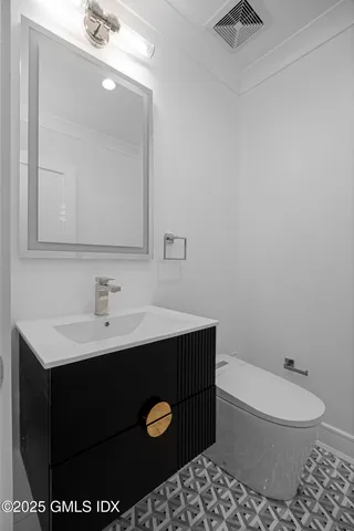 a bathroom with a sink toilet and mirror