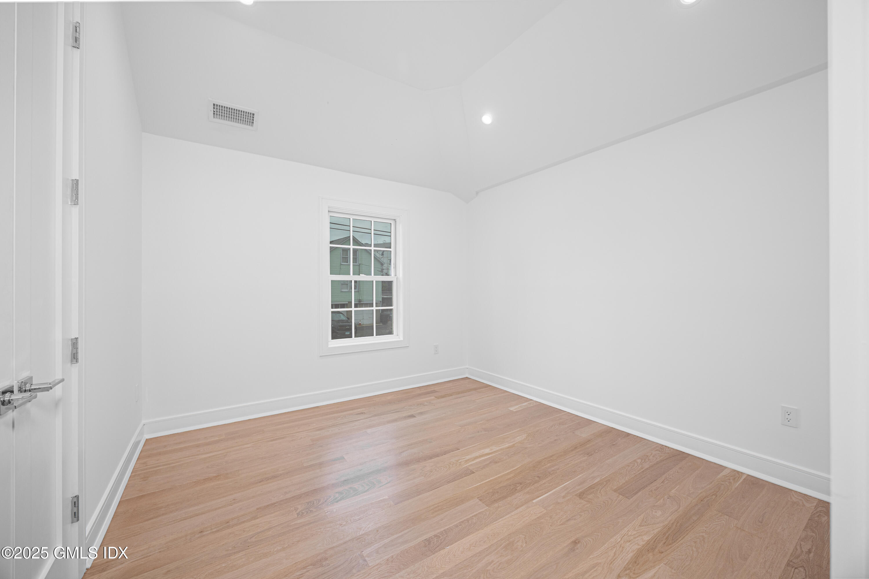82 Josephine Evaristo Avenue Greenwich, CT 06830 - Photo 8 of 13 an empty room with wooden floor and windows