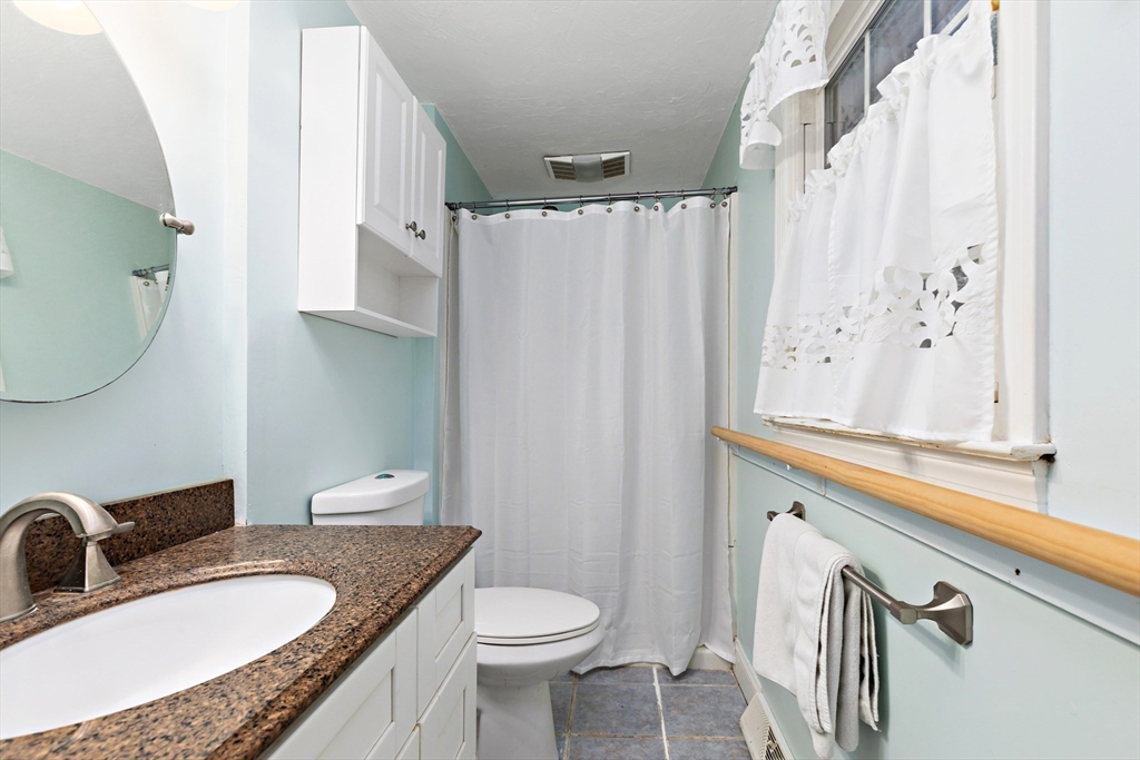 102 Turtleback Road Barnstable, MA 02648 - Photo 14 of 20 a bathroom with a granite countertop sink and a mirror