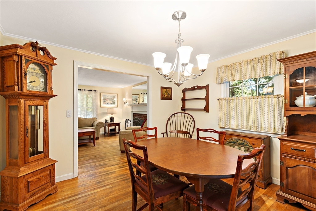 102 Turtleback Road Barnstable, MA 02648 - Photo 7 of 20 a view of a dining room with furniture a chandelier and wooden floor