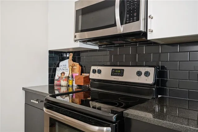 a stove top oven sitting inside of a kitchen