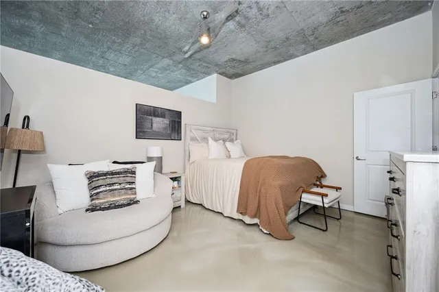 a bedroom with furniture and a lamp