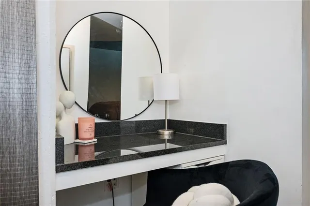 a living room with table and a mirror