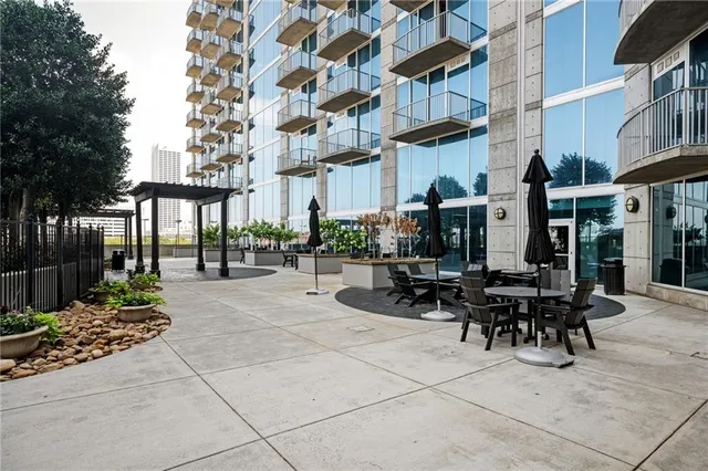 a view of a patio with a table and chairs and potted plants