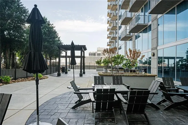 a view of a patio with table and chairs and potted plants
