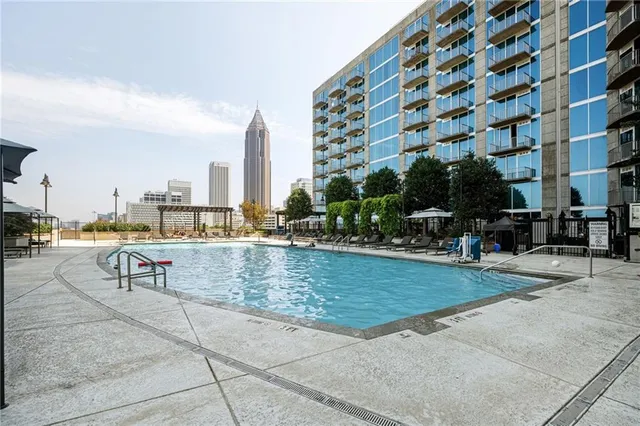 a view of a swimming pool with outdoor seating