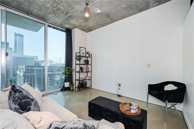 a living room with furniture and a floor to ceiling window