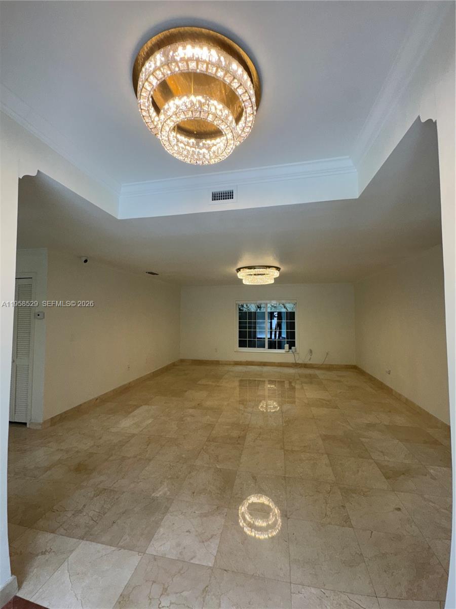 3185 Washington Street Miami, FL 33133 - Photo 27 of 48 an empty room with a chandeliers fan