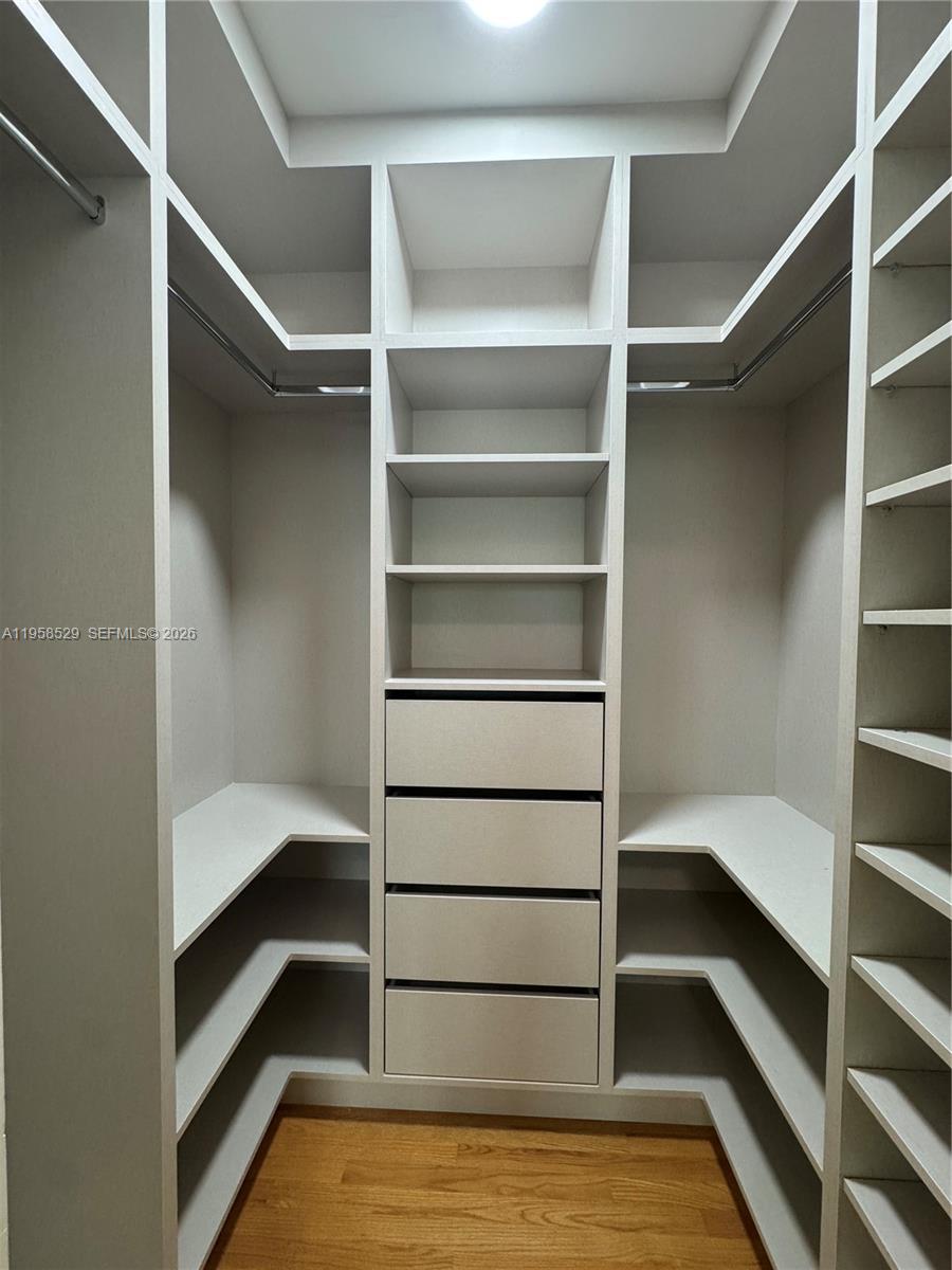 3185 Washington Street Miami, FL 33133 - Photo 29 of 48 a view of walk in closet with empty racks