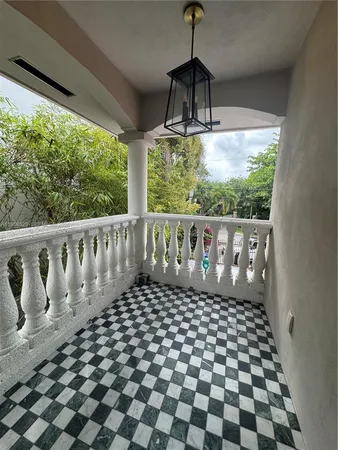 a living room with a fireplace furniture a potted plant and a fireplace