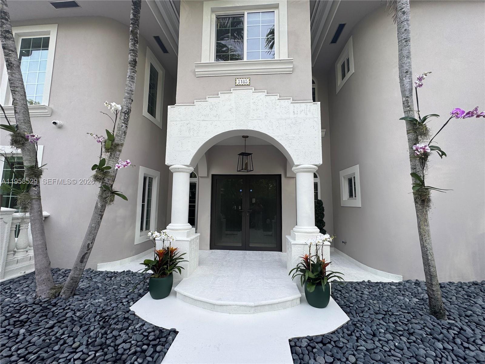 3185 Washington Street Miami, FL 33133 - Photo 33 of 48 a living room with a fireplace furniture a potted plant and a fireplace
