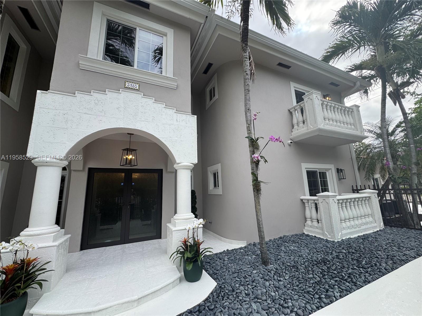 3185 Washington Street Miami, FL 33133 - Photo 40 of 48 a front view of a house with a white door