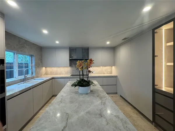 a view of a kitchen with a sink and windows
