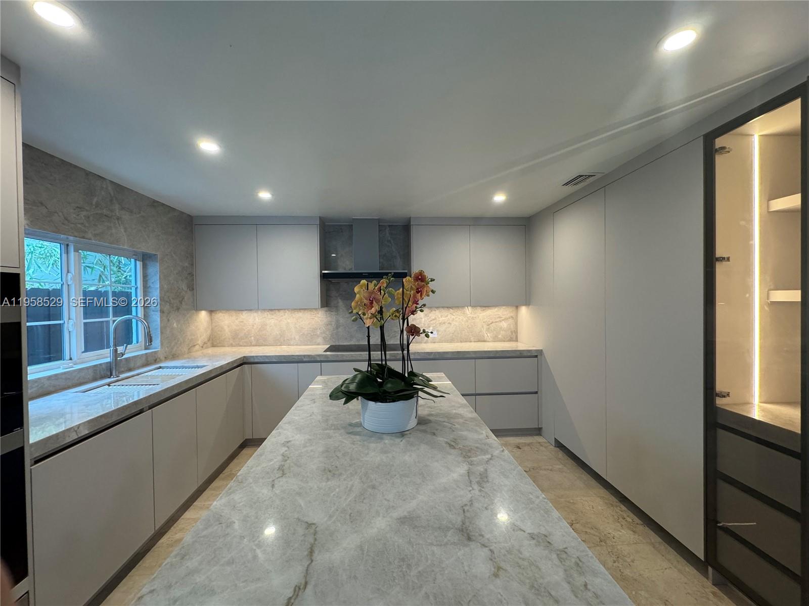 3185 Washington Street Miami, FL 33133 - Photo 4 of 48 a view of a kitchen with a sink and windows