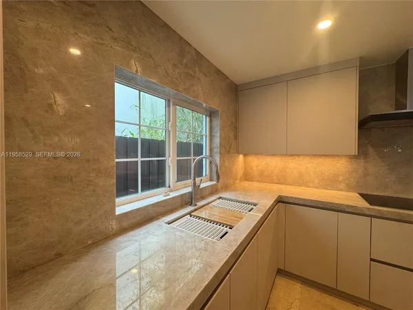 a view of a kitchen with a sink and dishwasher
