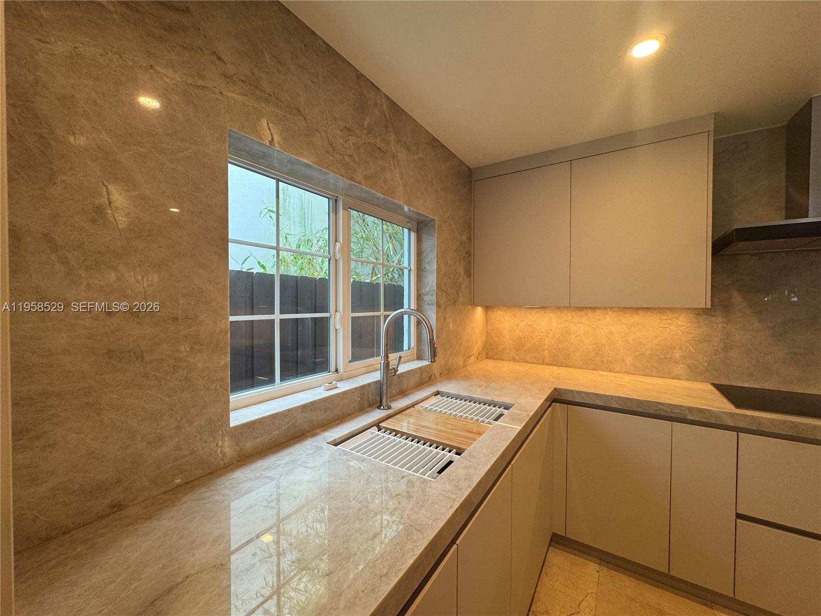3185 Washington Street Miami, FL 33133 - Photo 6 of 48 a view of a kitchen with a sink and dishwasher