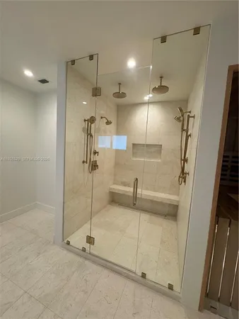 a bathroom with a shower and a glass door