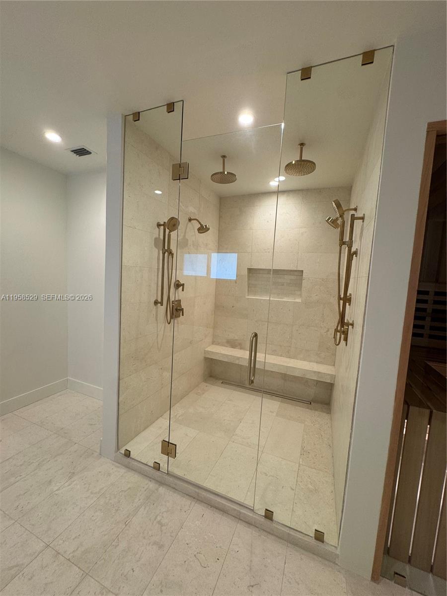 3185 Washington Street Miami, FL 33133 - Photo 9 of 48 a bathroom with a shower and a glass door