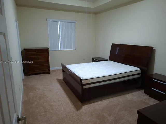 a bedroom with a bed and dresser
