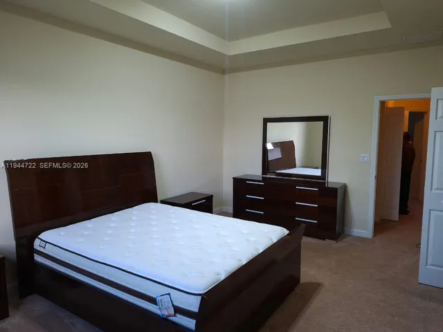 a bedroom with a bed and a dresser