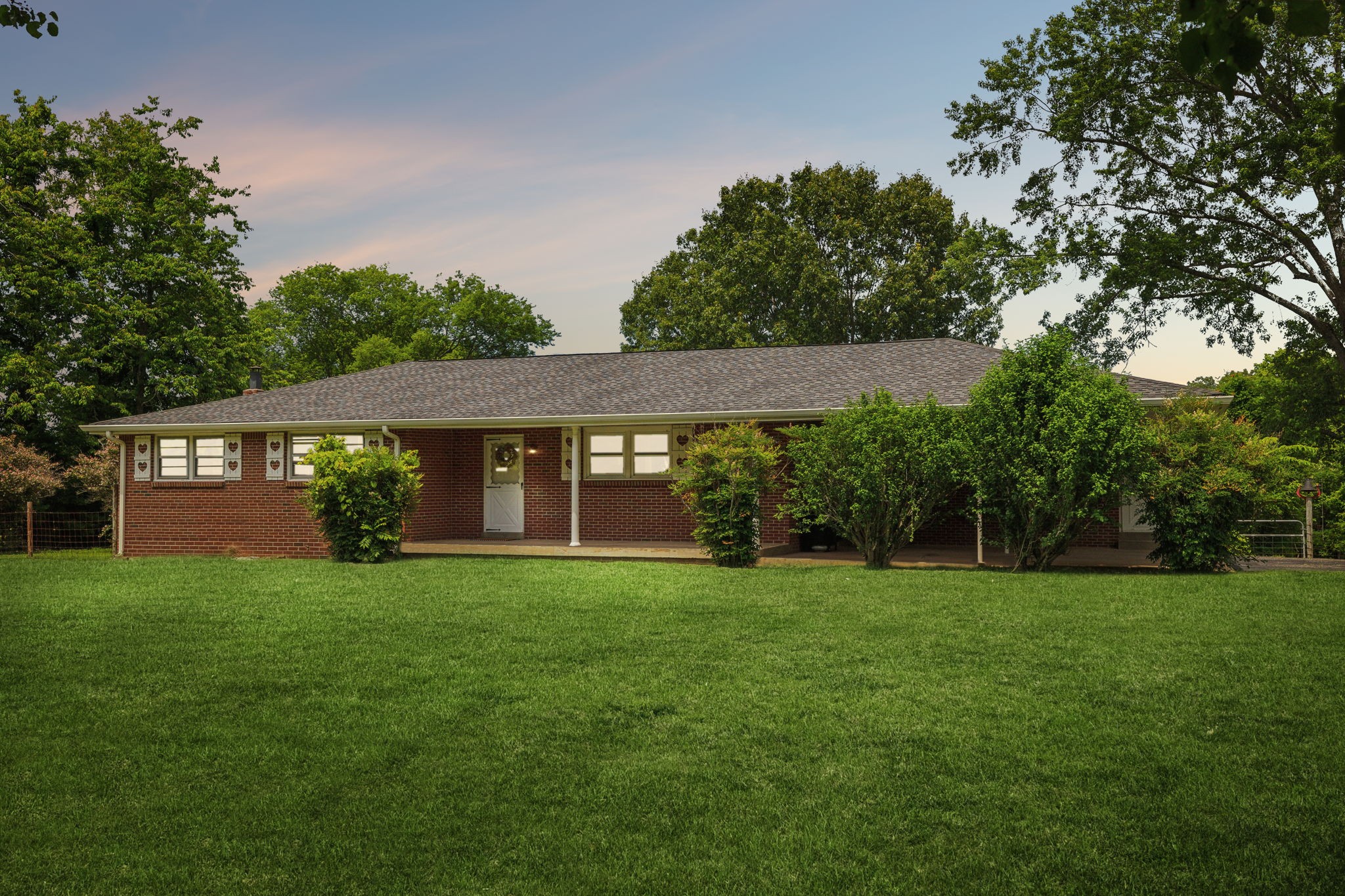 2747 Burgess Gower Road Springfield, TN 37172 - Photo 62 of 65 a view of a brick house with a big yard and large trees
