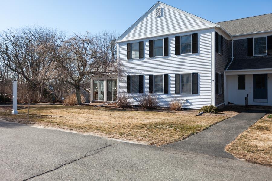 99 Depot Road, Unit 24 Chatham, MA 02633 - Photo 15 of 17 a front view of a house with a garden