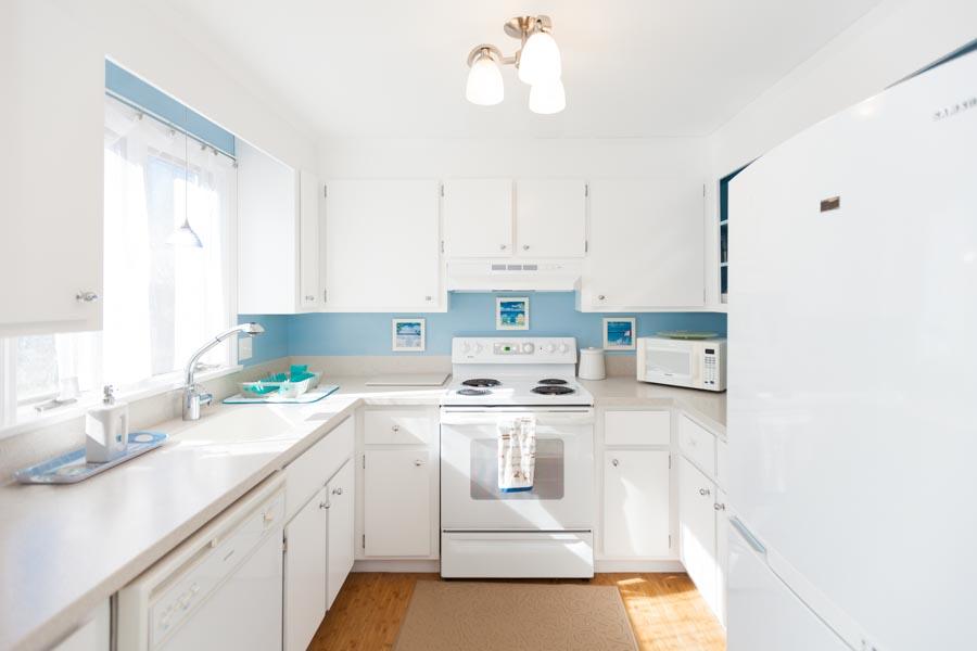 99 Depot Road, Unit 24 Chatham, MA 02633 - Photo 5 of 17 a kitchen with a sink cabinets and window