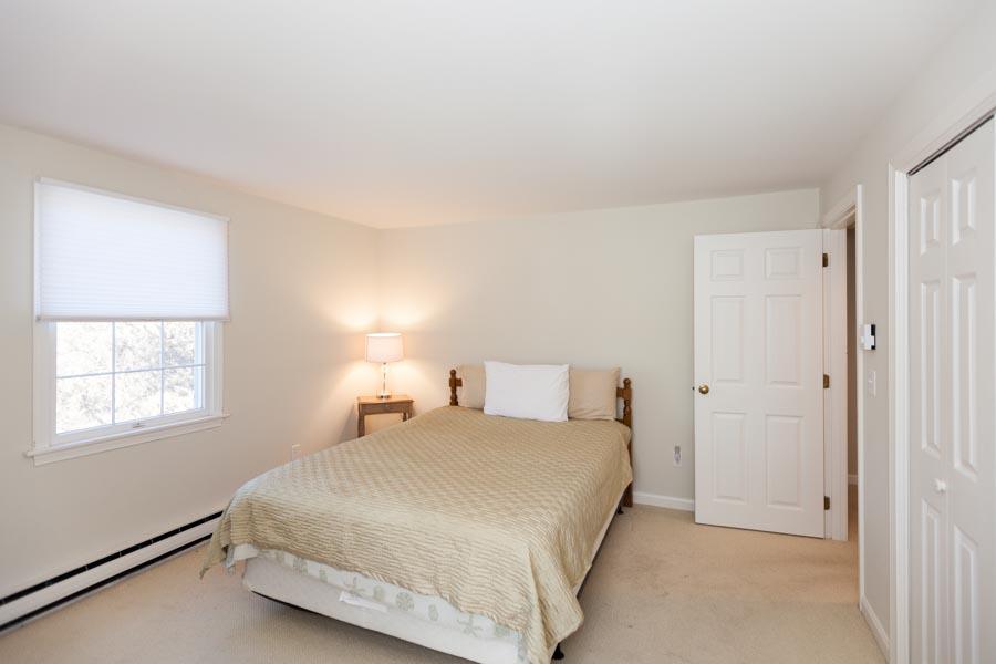 99 Depot Road, Unit 24 Chatham, MA 02633 - Photo 9 of 17 a bedroom with a bed and a window