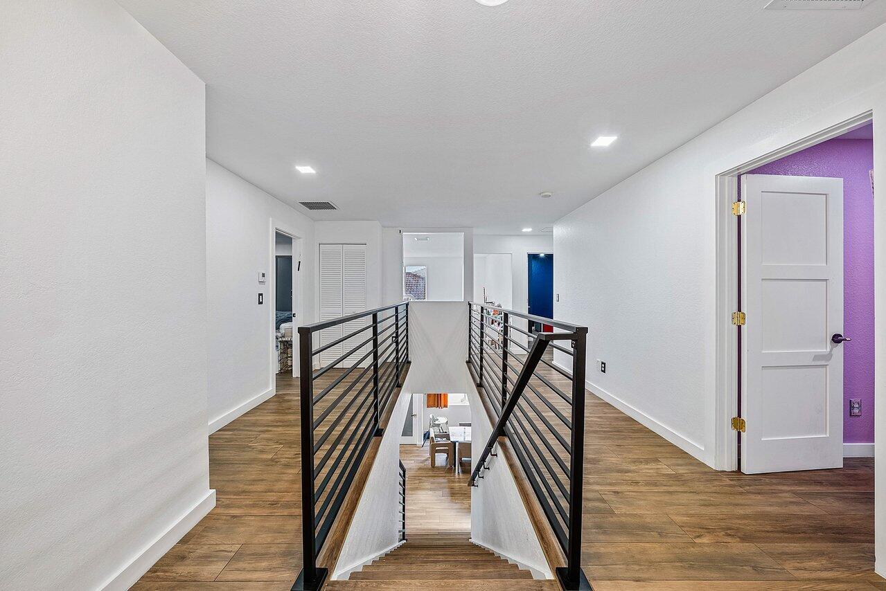10223 Boca Vista Drive Boca Raton, FL 33498 - Photo 15 of 33 a view of a hallway with wooden floor and stairs