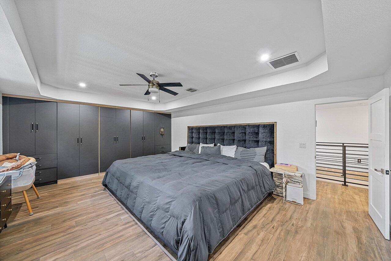 10223 Boca Vista Drive Boca Raton, FL 33498 - Photo 16 of 33 a spacious bedroom with a bed and a table