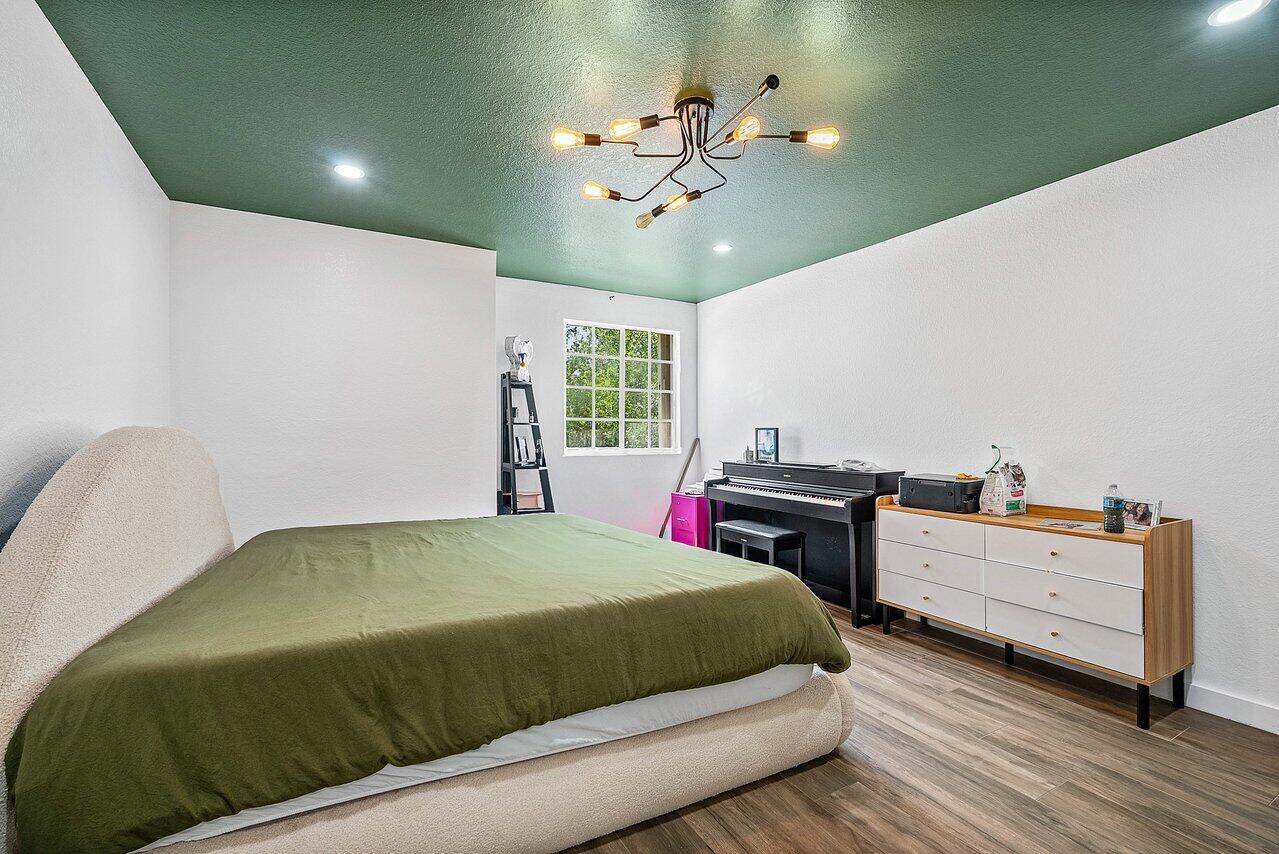 10223 Boca Vista Drive Boca Raton, FL 33498 - Photo 22 of 33 a bedroom with a bed and window