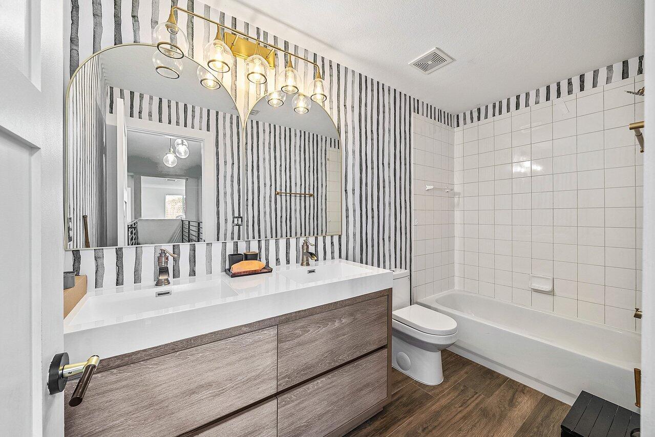 10223 Boca Vista Drive Boca Raton, FL 33498 - Photo 23 of 33 a bathroom with a sink a toilet and shower