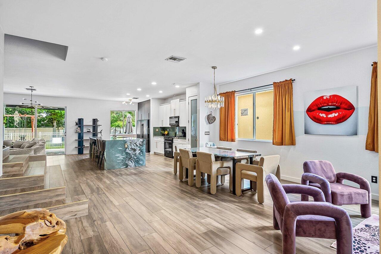 10223 Boca Vista Drive Boca Raton, FL 33498 - Photo 6 of 33 a living room with lots of furniture and kitchen view