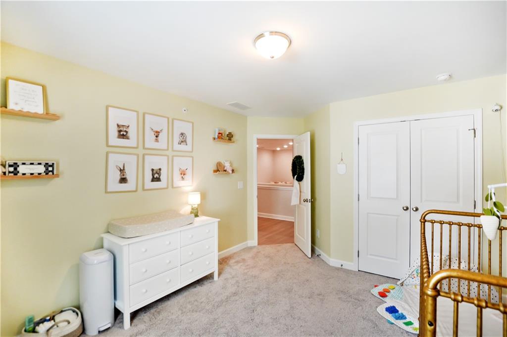765 Trevett Way Marietta, GA 30066 - Photo 27 of 44 a living room with furniture and baby crib