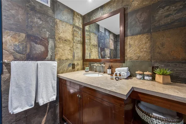 a bathroom with a glass shower door