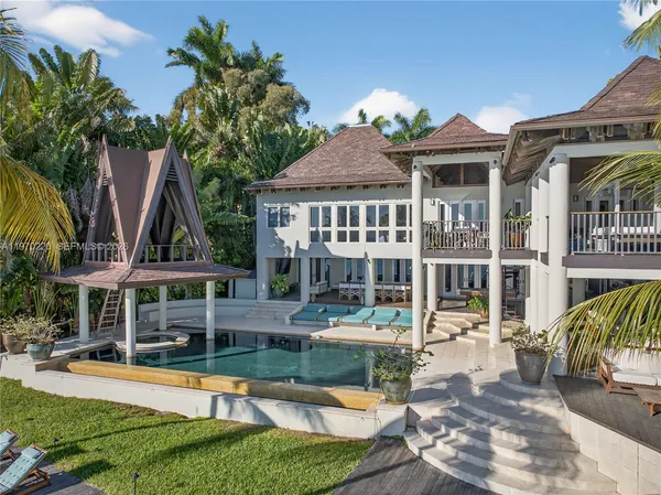 a view of a house with swimming pool and sitting area