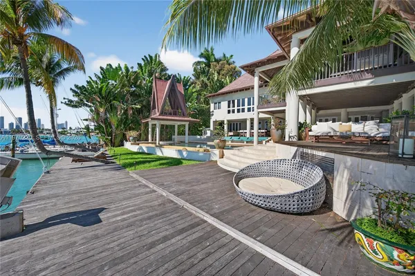 a view of a house with swimming pool and sitting area