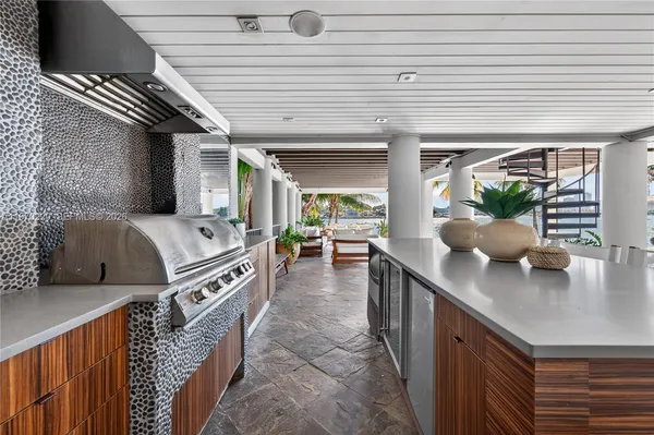 a view of a balcony with wooden floor table and chairs