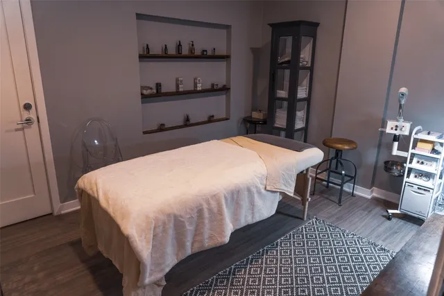 a bedroom with a bed and a book shelf