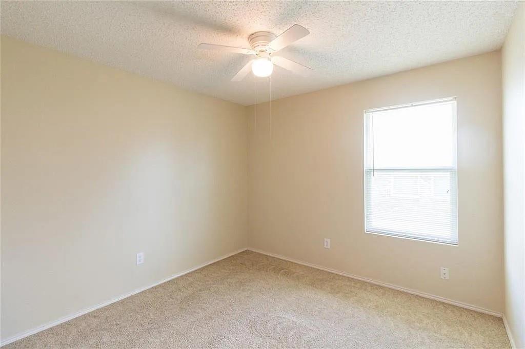118 Scarlet View Anna, TX 75409 - Photo 13 of 16 an empty room with a window and a ceiling fan