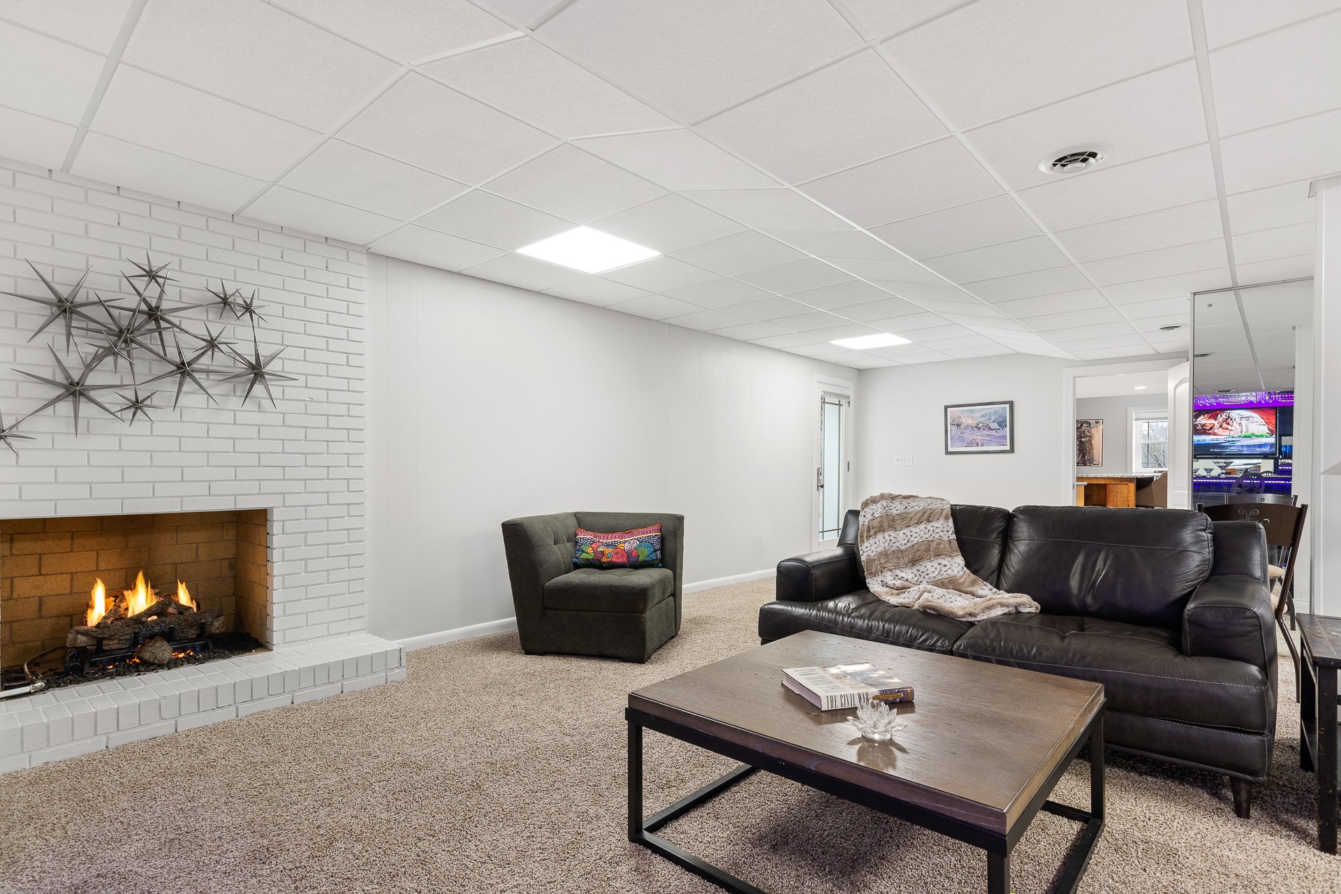 6607 Fox Hollow Road Nashville, TN 37205 - Photo 34 of 50 a living room with furniture a fireplace and a flat screen tv