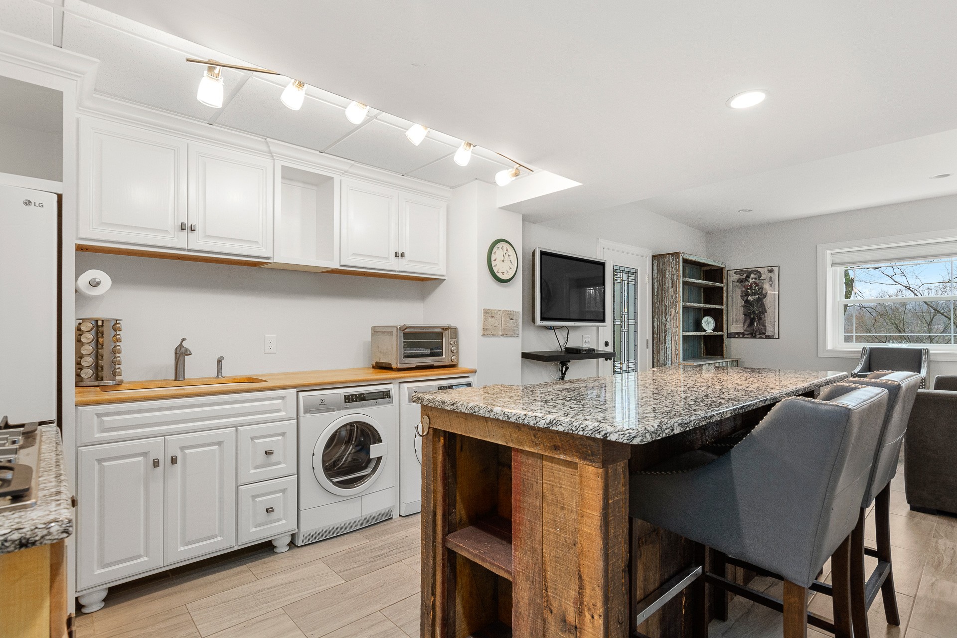 6607 Fox Hollow Road Nashville, TN 37205 - Photo 36 of 50 a kitchen with stainless steel appliances granite countertop a table chairs sink and cabinets